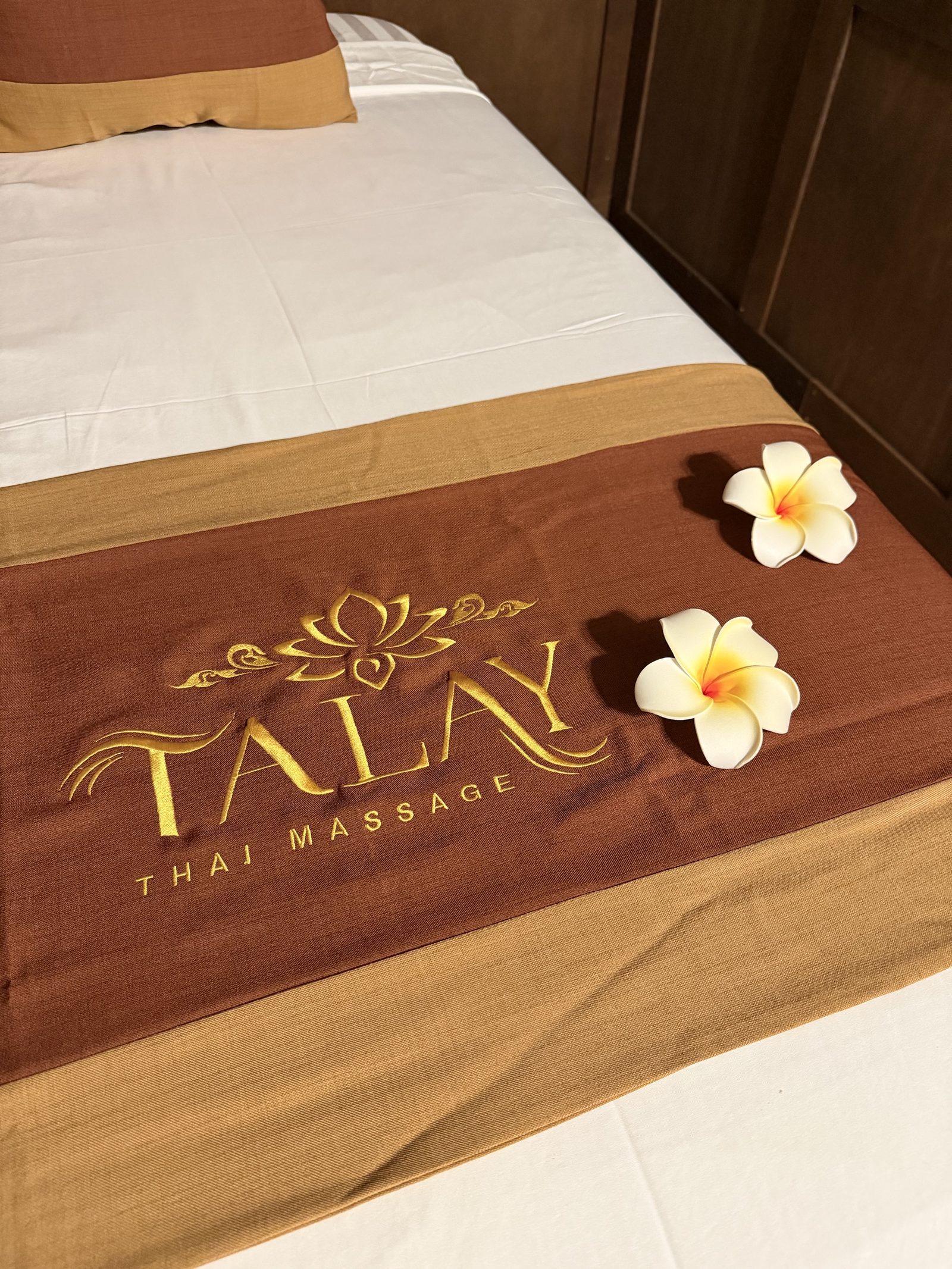Talay Thai Massage bed linens with plumeria flowers