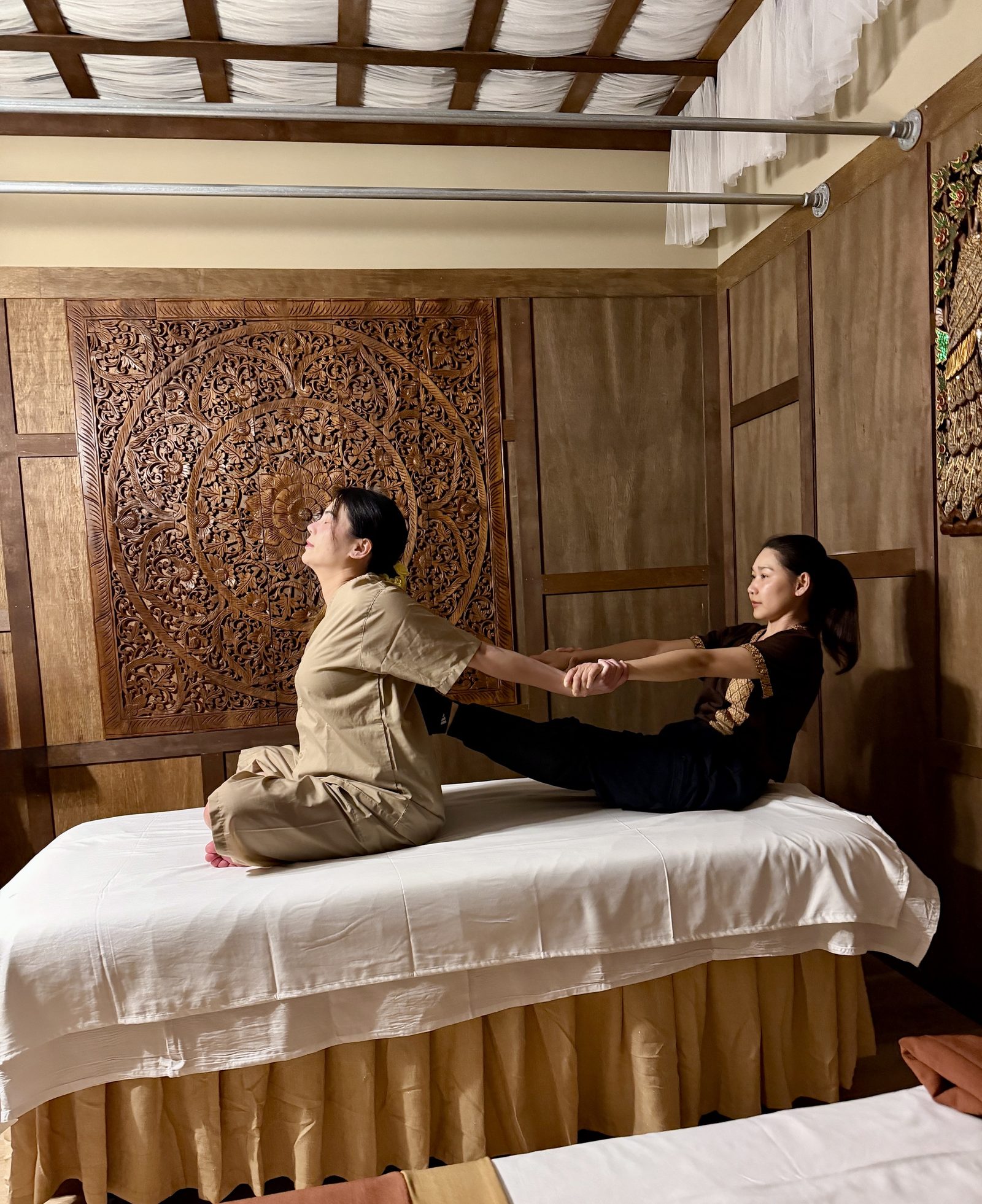 Therapist demonstrating an assisted Thai stretch